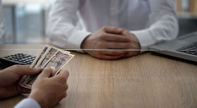 Person handing over money at Pairvii-Legal.