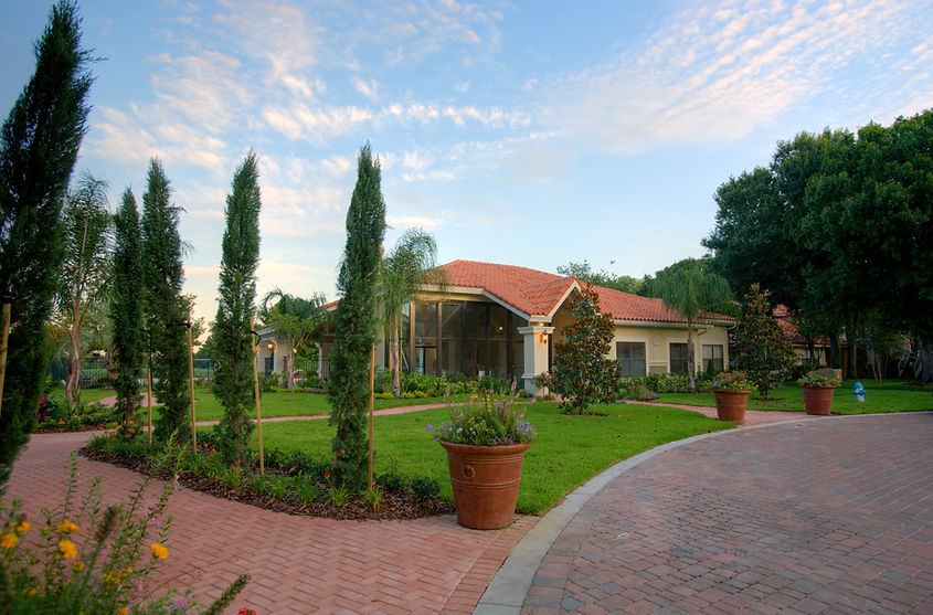 house exterior with garden and trees