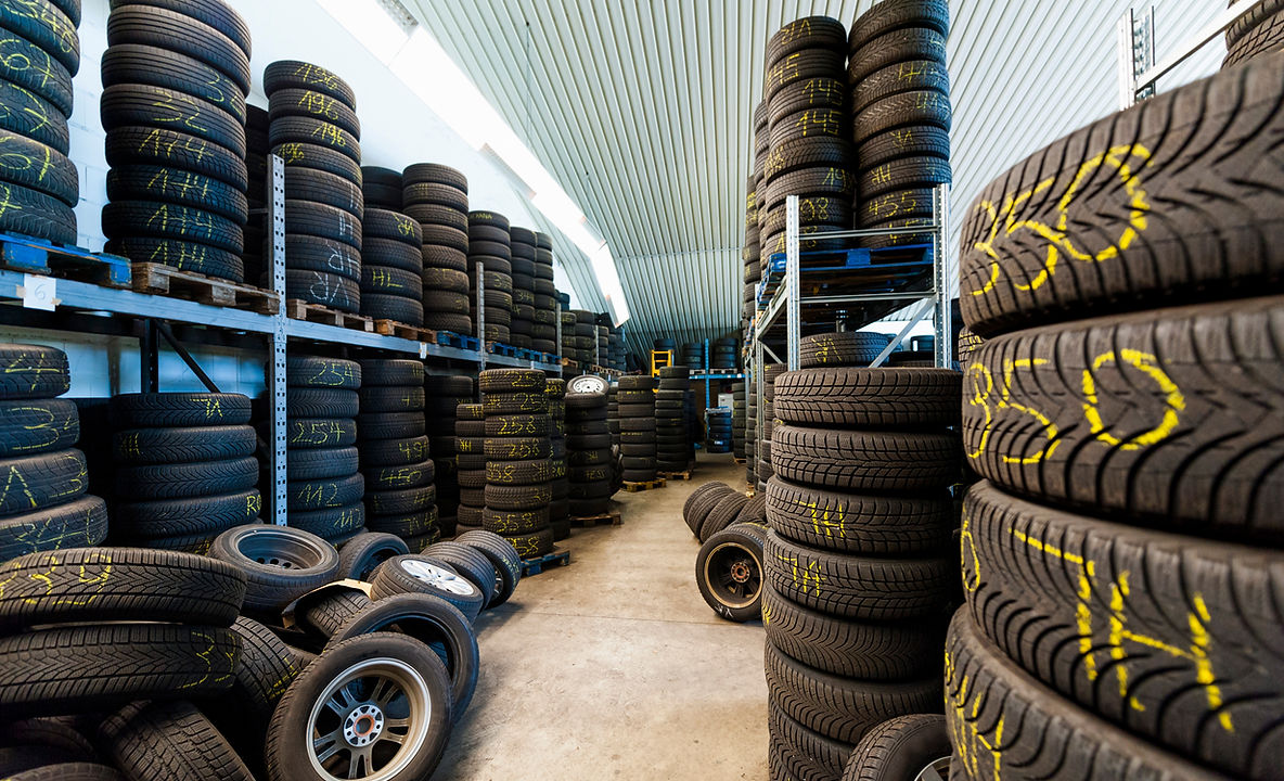 Rows of stacked tyres in a garage