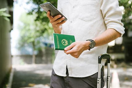 Vietnamese man watching smartphone while holding a passport