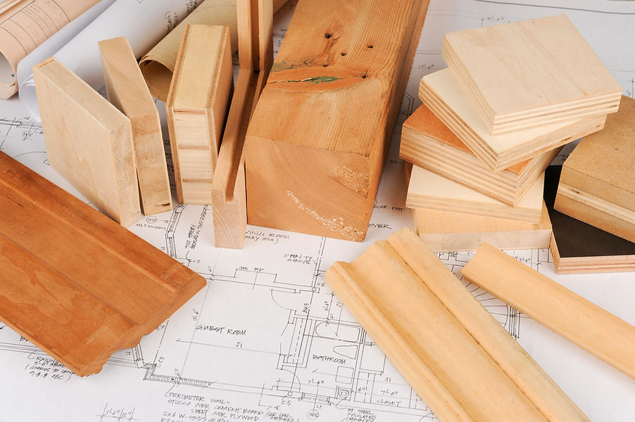 mouldings and plywood samples over house renovation blueprint