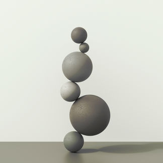 Different sized balls balanced on top of each other