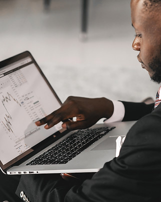 A man pointing at his laptop screen