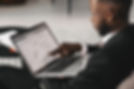 A man pointing at his laptop screen