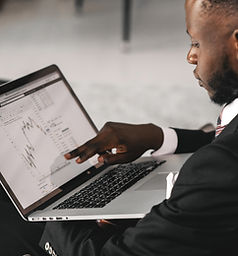 A man pointing at his laptop screen