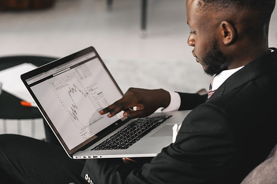 A man pointing at his laptop screen