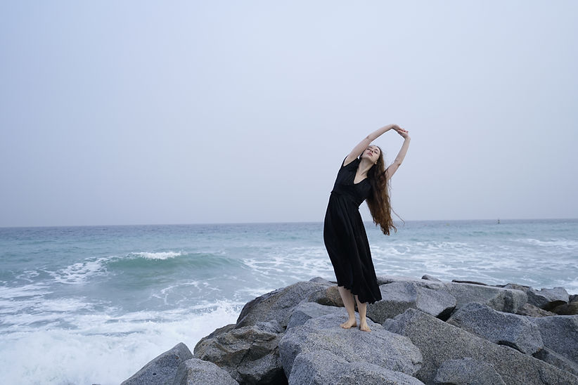 Woman On Rocky Beach