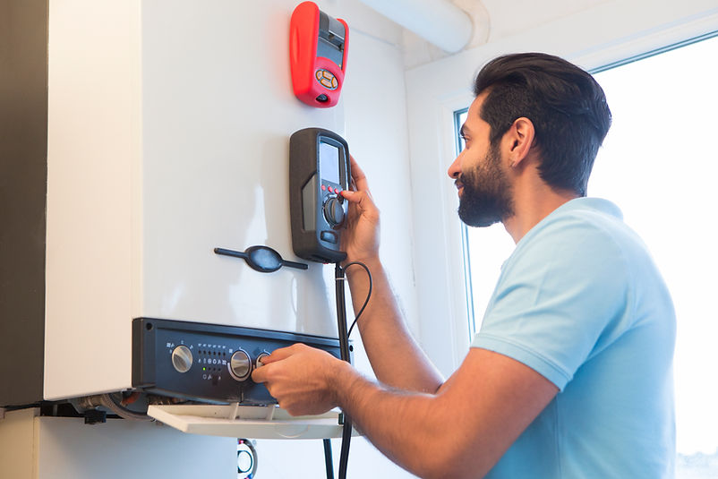 A gas engineer inspecting a heating system