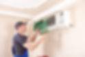 A technician removes a green air conditioner filter for maintenance