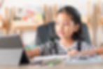 A girl doing free online lessons during homeschool studies