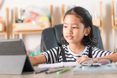 A Vietnamese girl studying online at home
