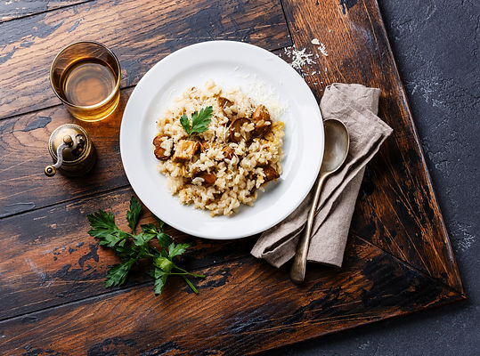 Risotto with mushroom on a wooden table