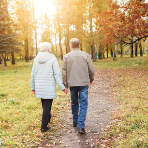 elderly couple outside walking