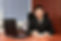 Person Sitting Behind Desk