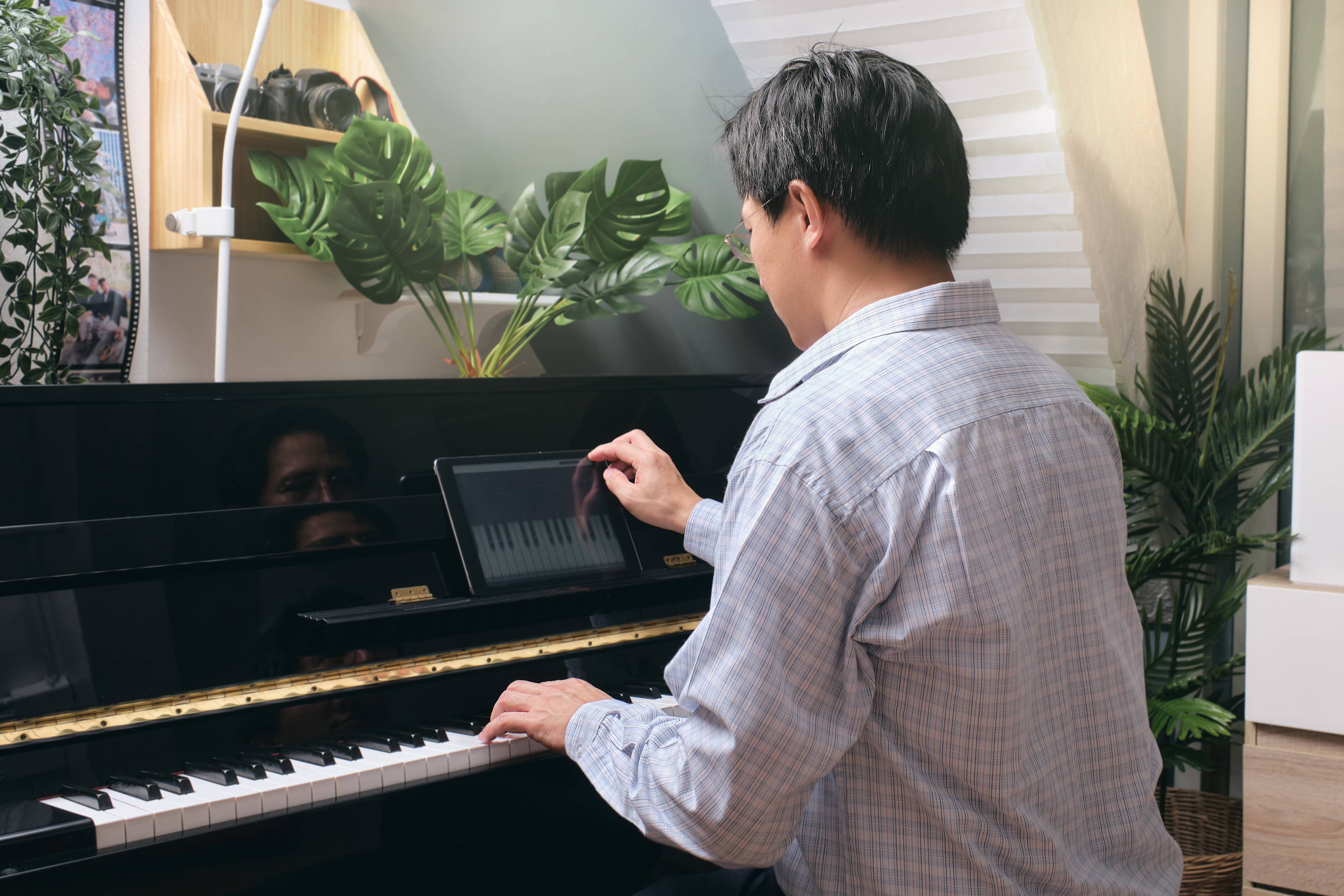 Eye-level view of a grand piano keyboard in a cozy London studio