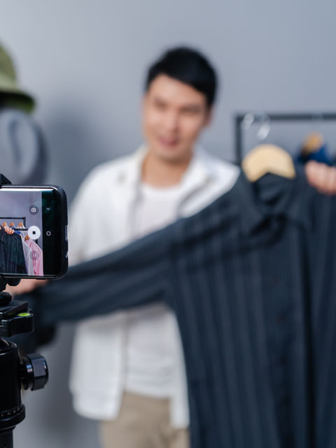A man selling clothes live