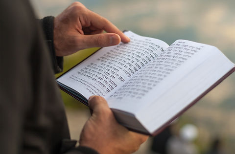 Holding a Prayer Book