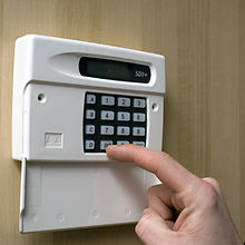 Image of a man setting a burglar alarm
