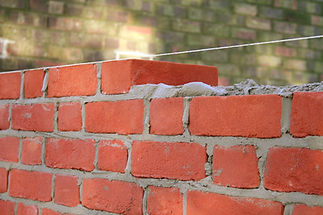 A close-up of a brick wall under construction