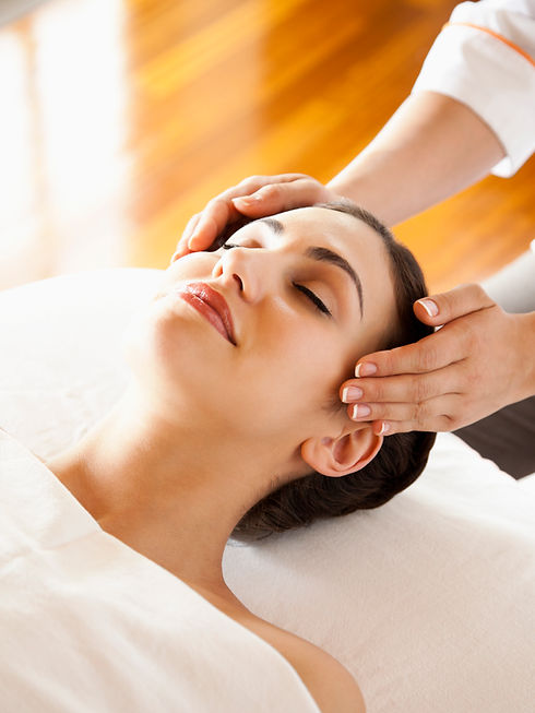 Overhead view of woman receiving scalp massage