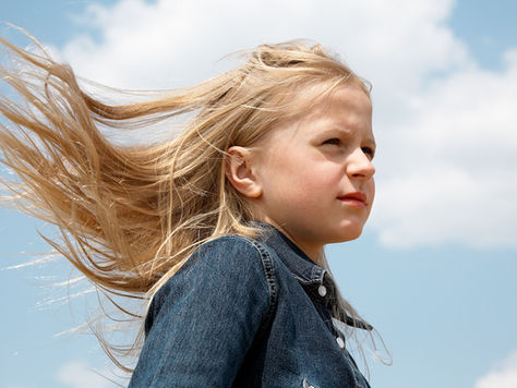 Child's hair blowing in the wind