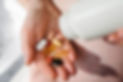 Hand holding various pills