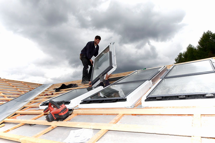 Workers installing roof windows