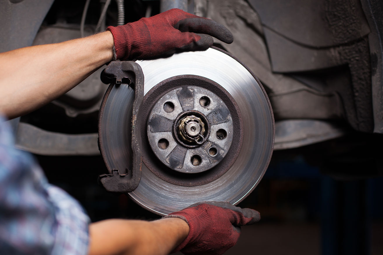 A professional repairing the car brakes