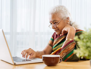 a senior working on a laptop