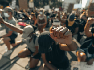 Protesters kneel with fists raised