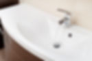 Faucet on a bathroom sink with flowing water