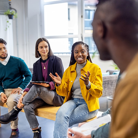Young woman sharing her view during team building session at startup office. African woman