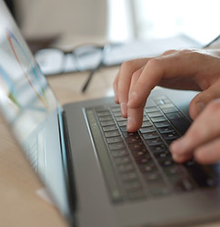 Businessman typing on laptop