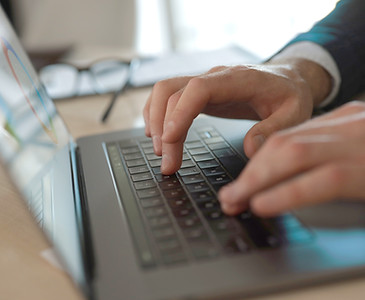 Businessman typing on laptop