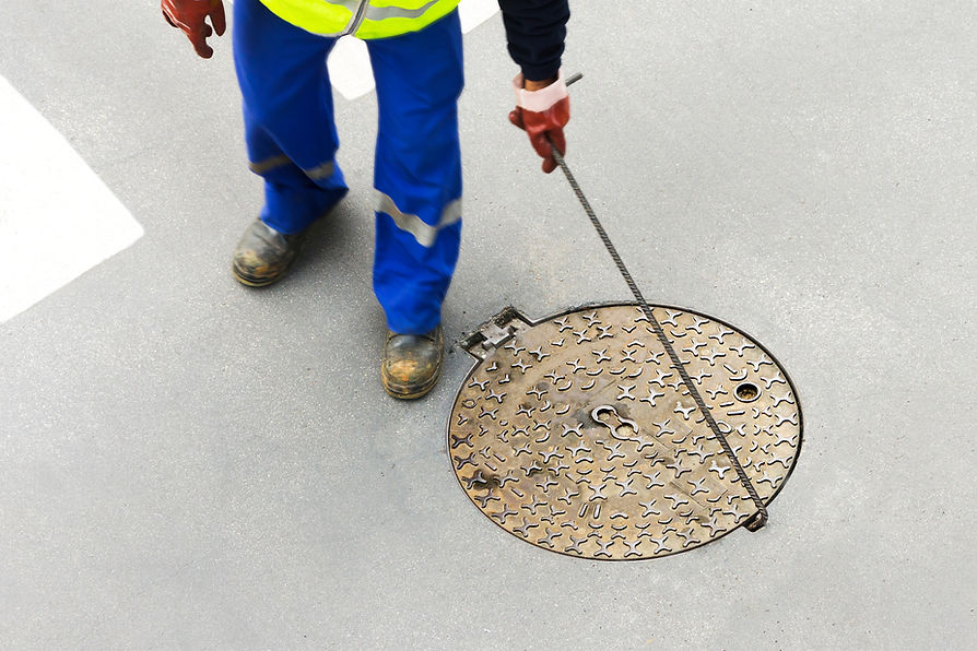 Worker Opening Manhole