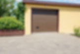 A brown garage door on a yellow building