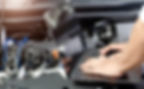 A mechanic using electronic equipment to diagnose a car