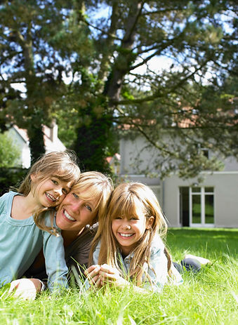Caring professional nanny playing with happy child in garden - luxury nanny services by Our Good Nanny Tampa Bay
