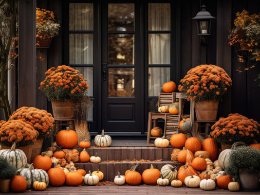 A cozy autumn porch adorned with vibrant orange chrysanthemums and a variety of pumpkins creates a warm and inviting seasonal display.