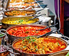 Freshly cooked food, served in woks