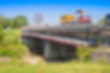 Restoration of an old damaged concrete bridge crossing a river with truck working