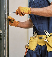 Repairman Fixing Door