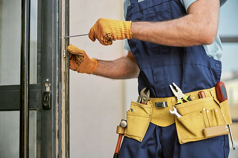 Technician repairing  door of a rental home exterior