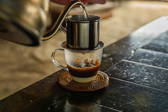 Adding water to Vietnamese phin coffee