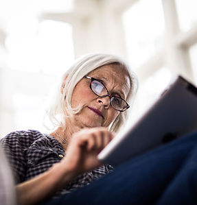A woman reading on her tablet device