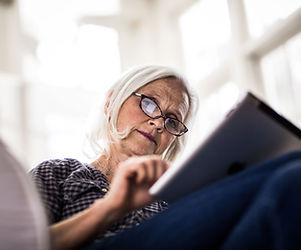 A woman reading on her tablet device