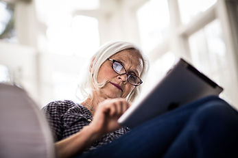 A woman reading on her tablet device