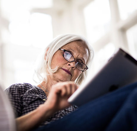 A woman reading on her tablet device