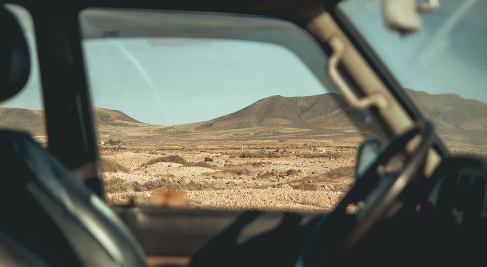View from car window of dry, mountainous desert
