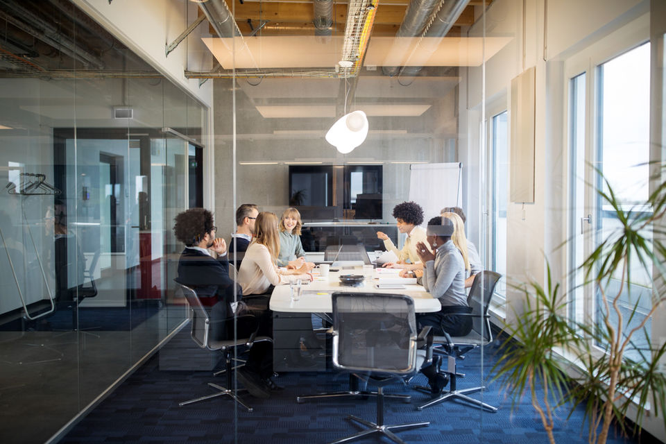 Board meeting, a background of glass wall and plants